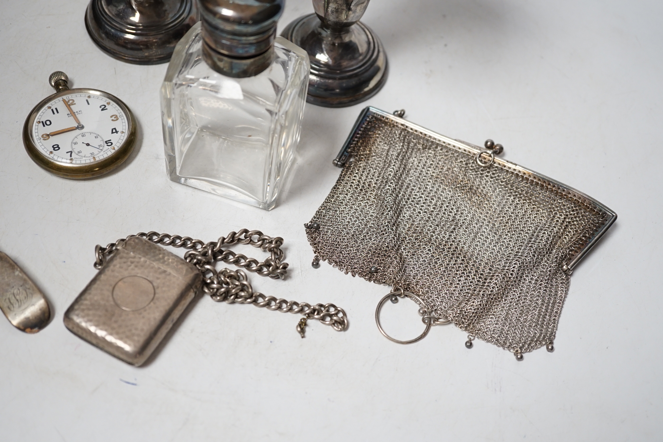 A matched pair of George V silver mounted posy vases, 16.3cm, together with a silver topped toilet jar, silver vesta case on a silver albert, a silver mesh evening bag, two silver spoons and a base metal pocket watch.